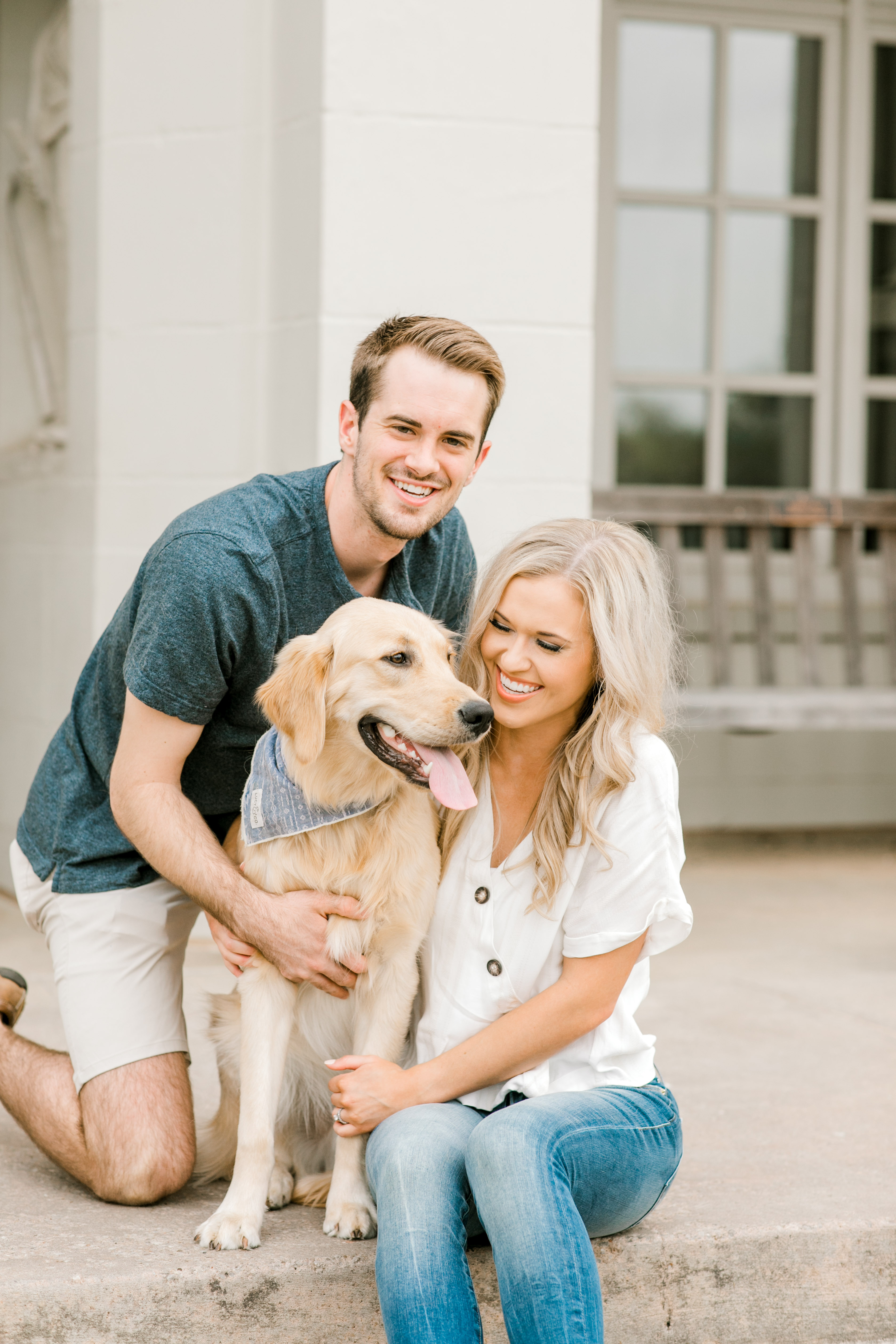 cute family laughs with golden retriever dog on ou campus