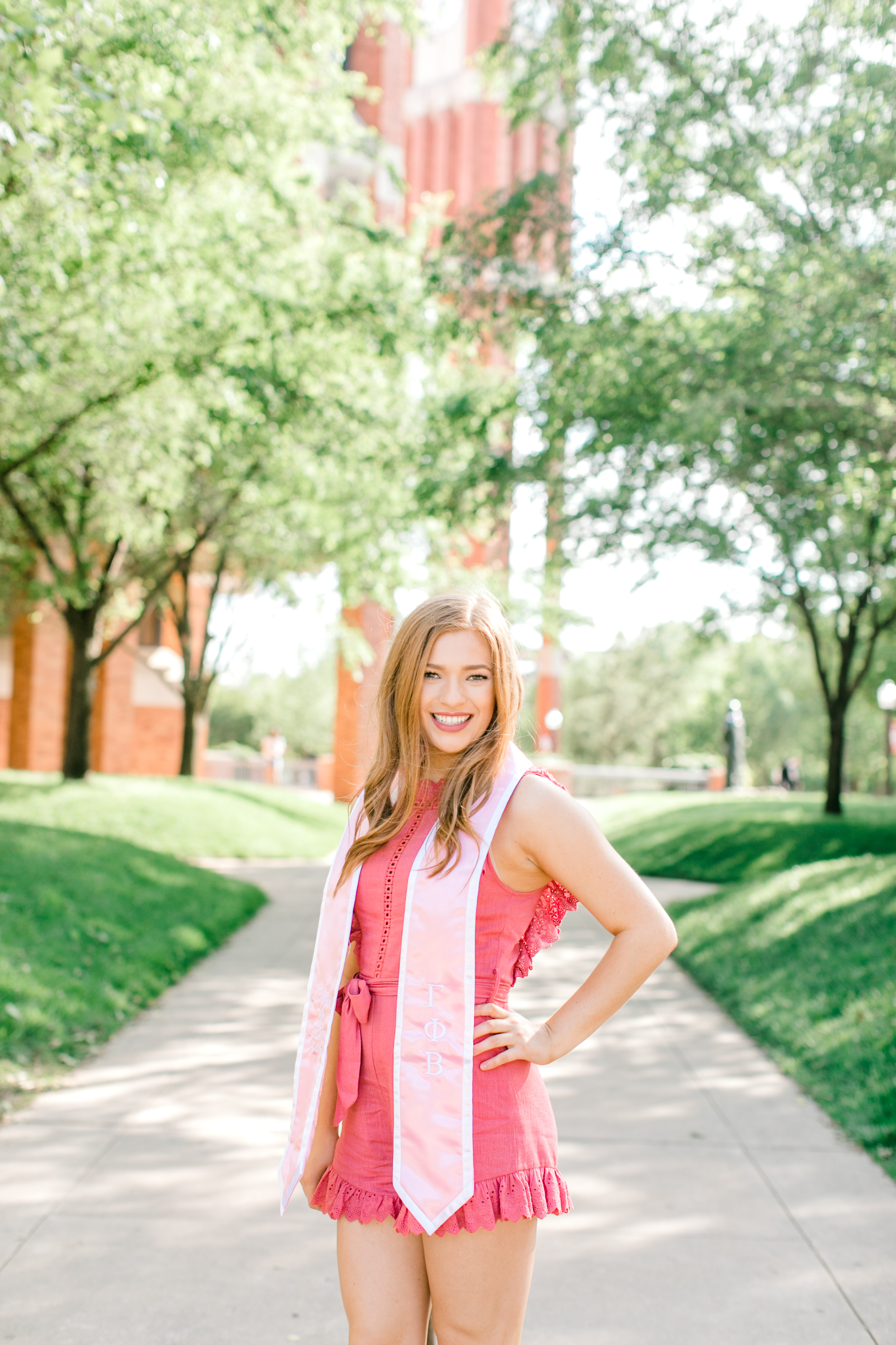 redhead poses in graduation stoll for ou senior photographer