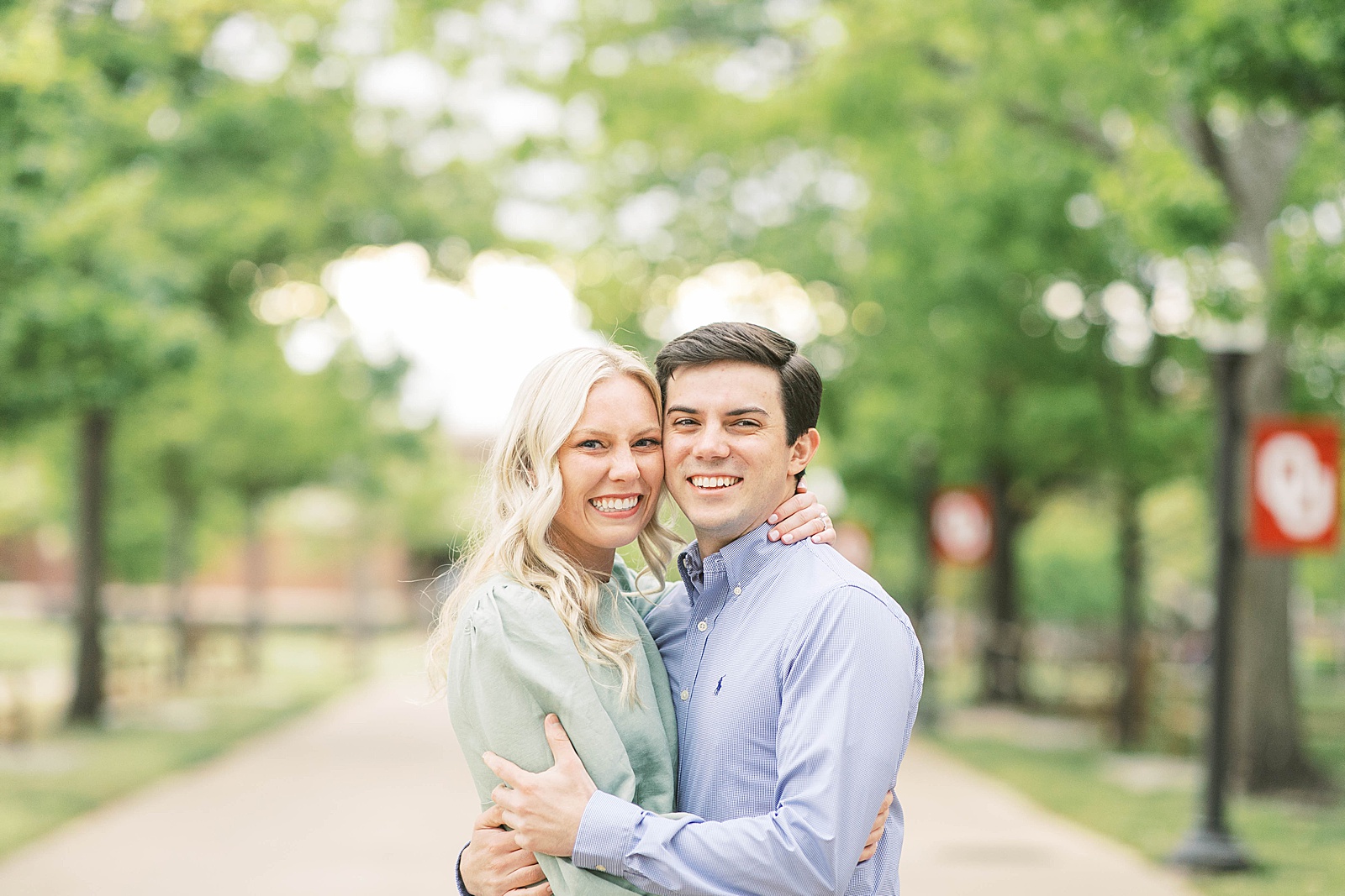 couple embraces celebrating spring proposal on campus at ou