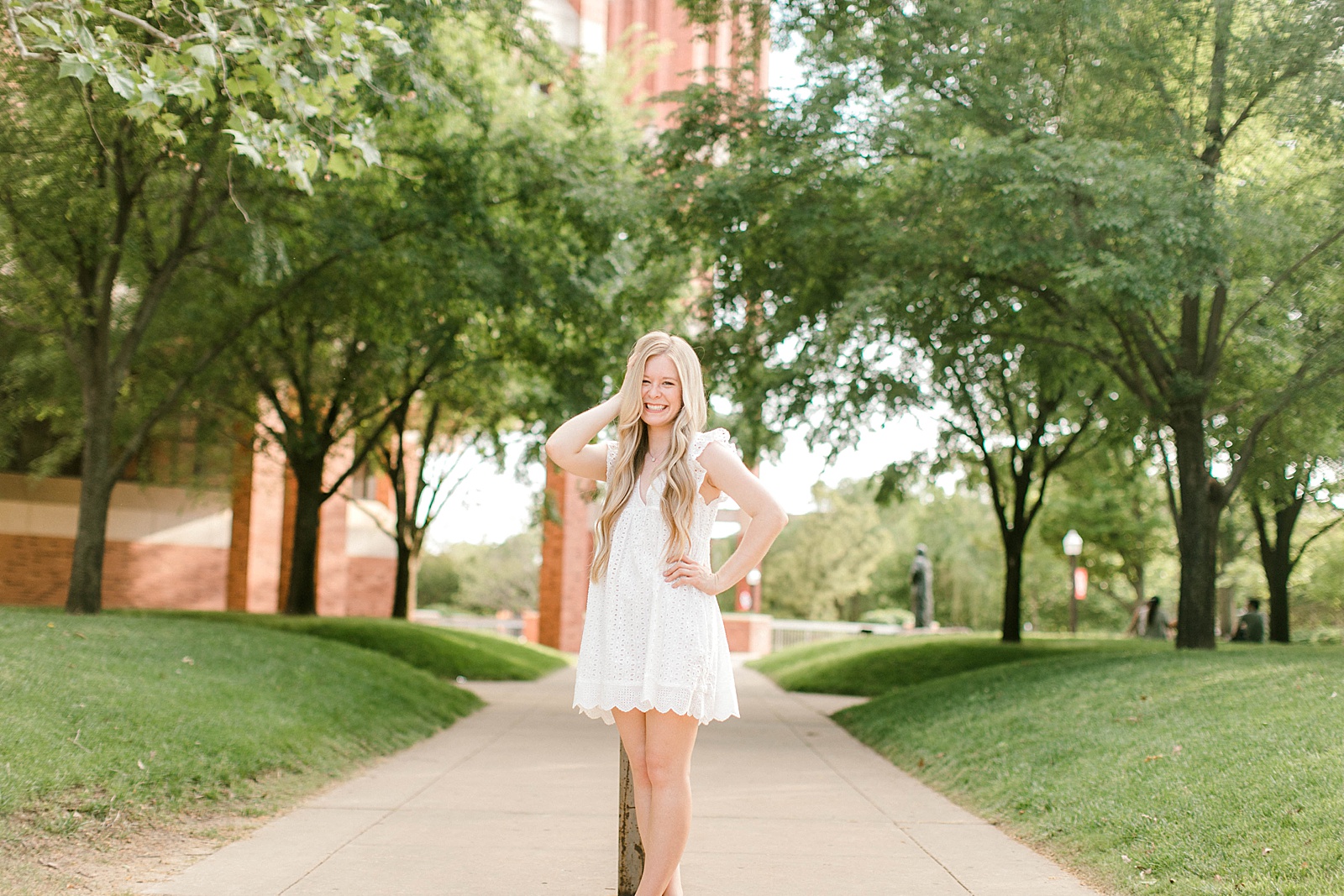 blonde college student celebrates with ou graduation photographer