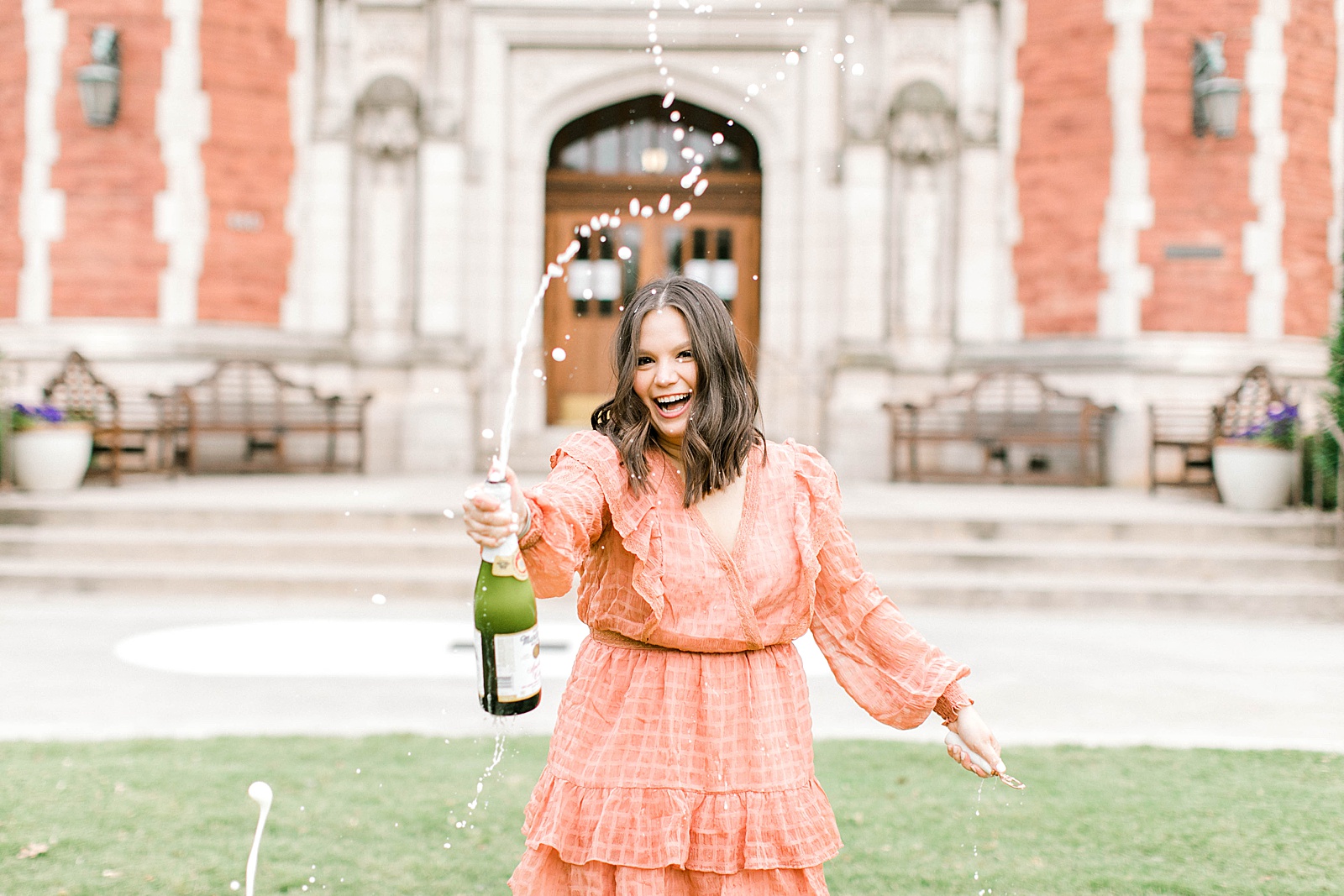 popping champagne for graduation photos