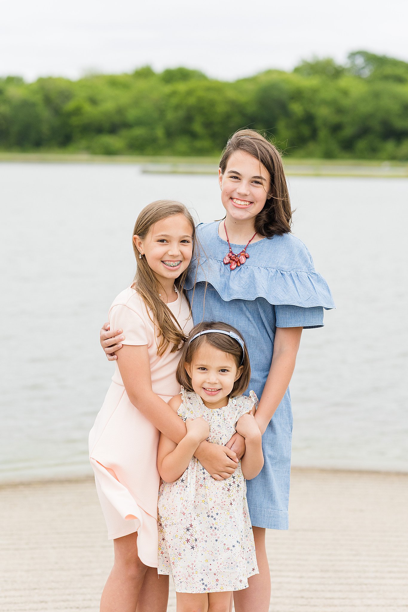 three sisters smile for family photos in bartlesville
