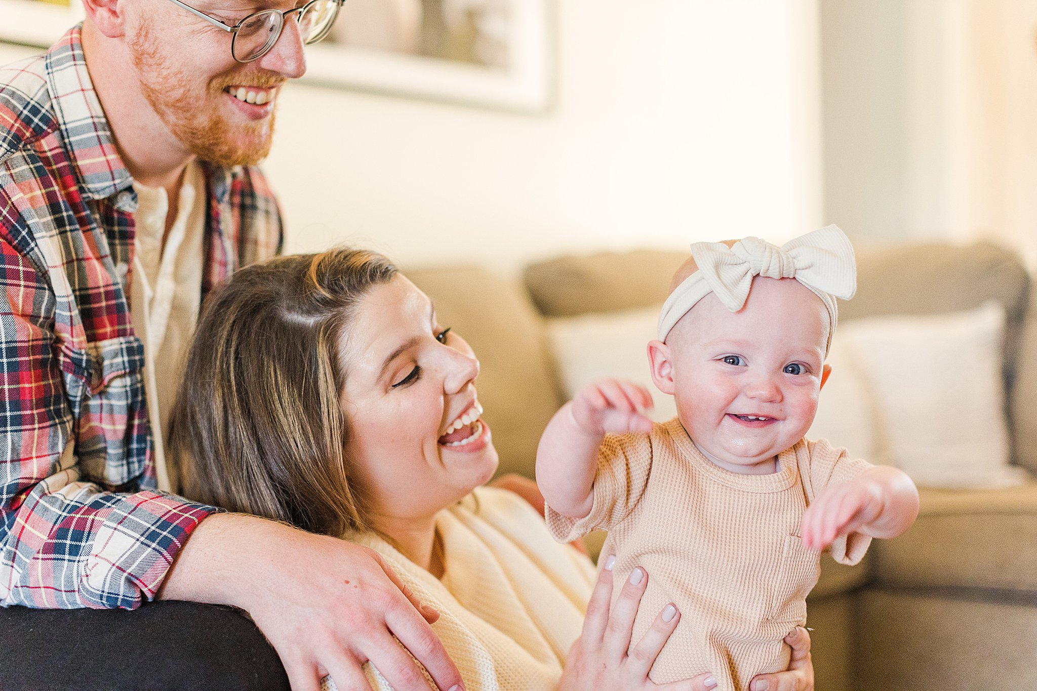 bartlesville family of three smiles for photos during in home session