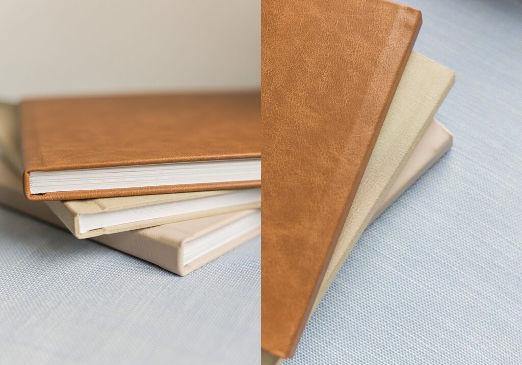 stack of heirloom albums from bishop kelley tulsa senior session