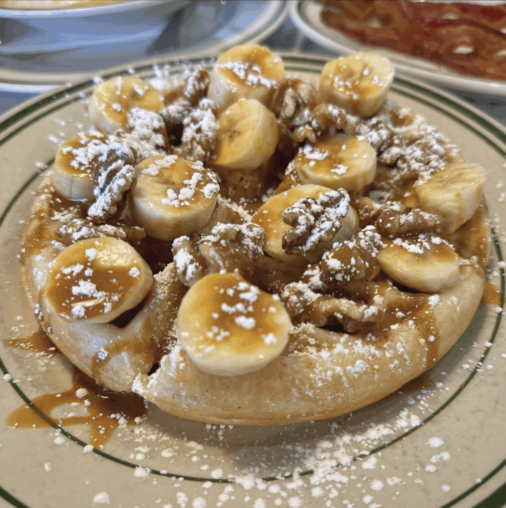 waffle loaded with bananas and powdered sugar at dilly diner - a family friendly resaurant in tulsa