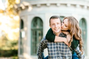 cute couple poses for engagement photos in woodward park tulsa