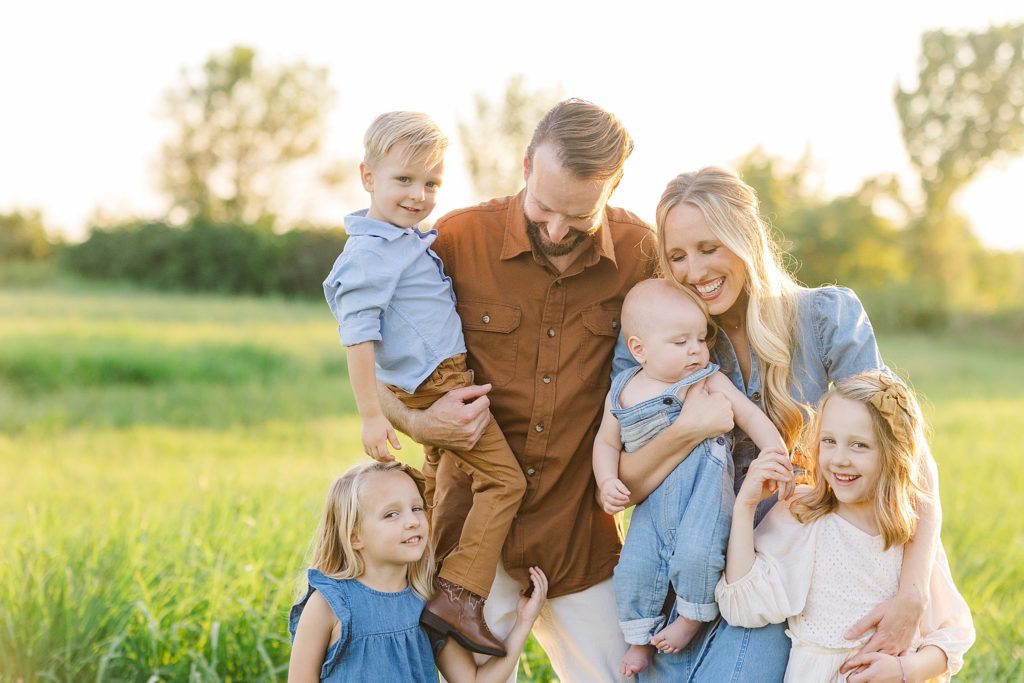 A family stands together for their family photo session with Bartlesville family photographer