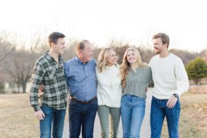Family stands together in field in Bartlesville for winter family photo session