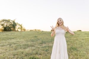 High school senior holds up two and three fingers for 2023 graduating class