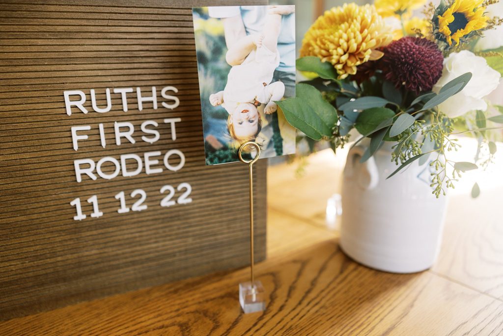 Ruths first rodeo board, flowers, and picture