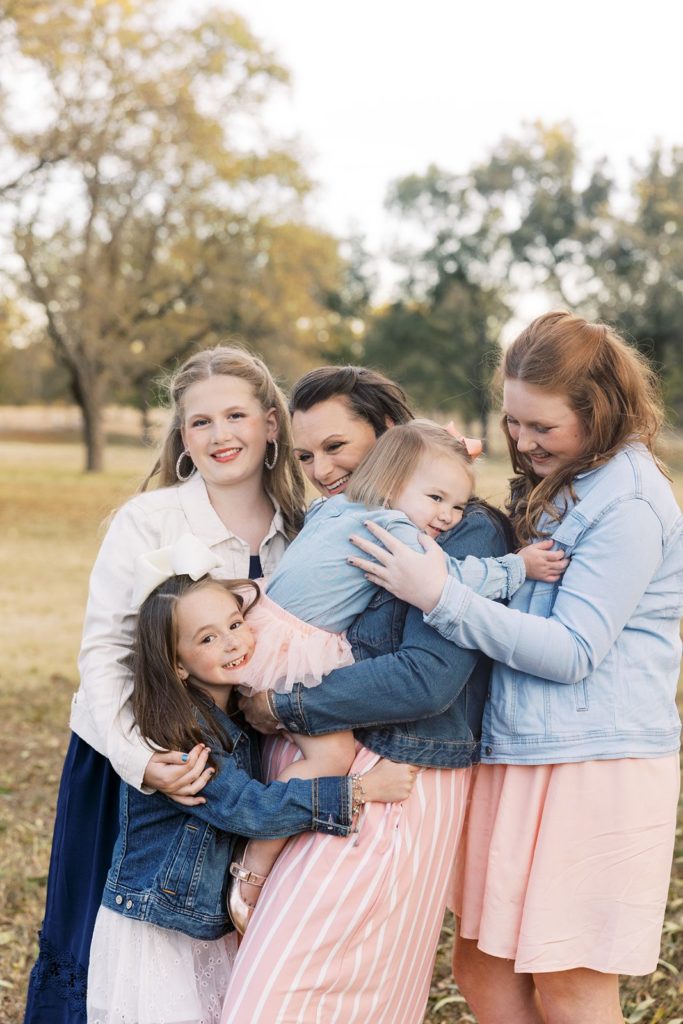 Mom poses with daughters during family portrait
